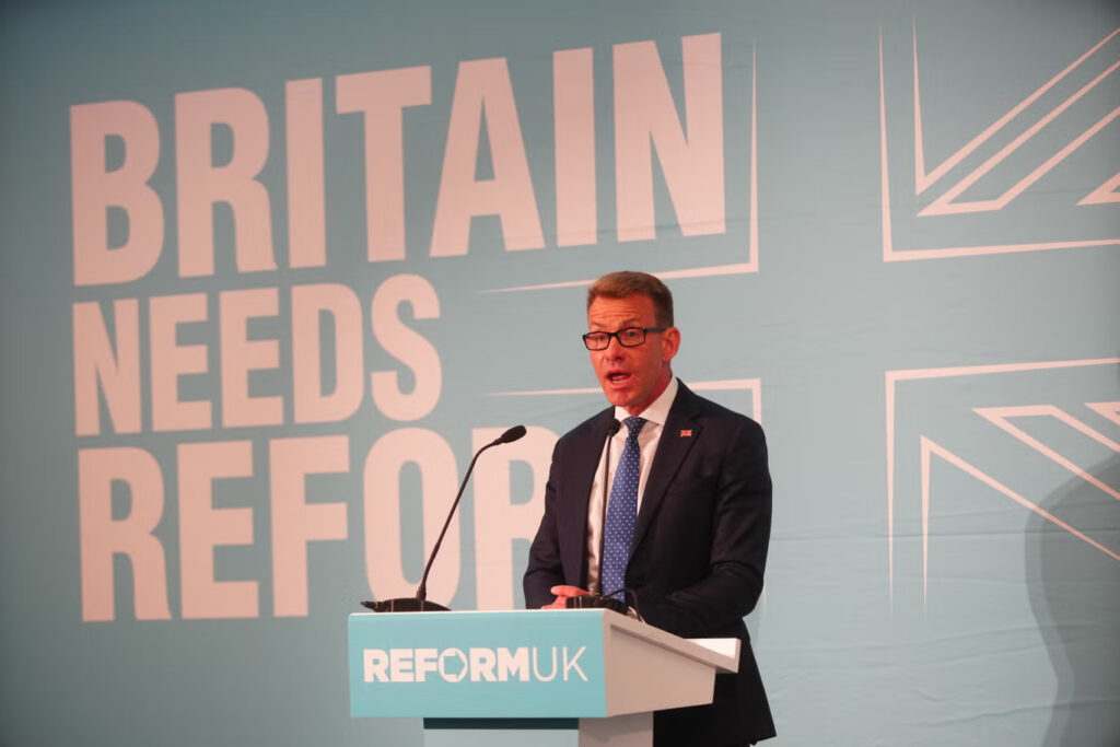David Bull in front of a Reform podium